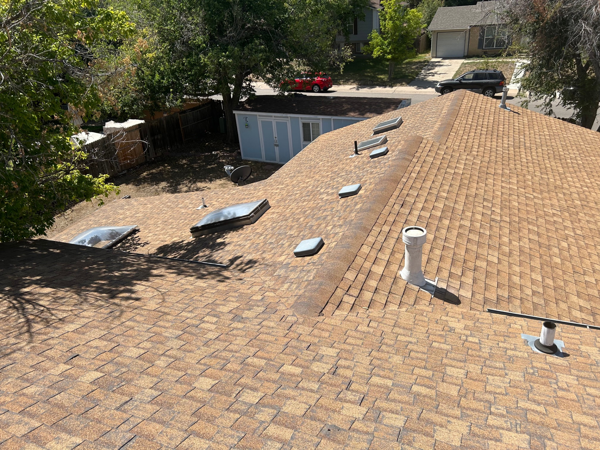 New asphalt shingle roof with skylights and vents on a Littleton, Colorado home