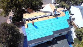 Aerial view of synthetic underlayment installed and lined out across the roof deck