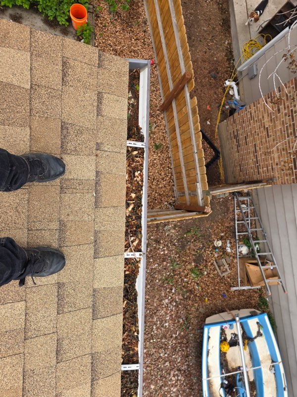 Open gutter full of leaves and debris before leaf guard installation