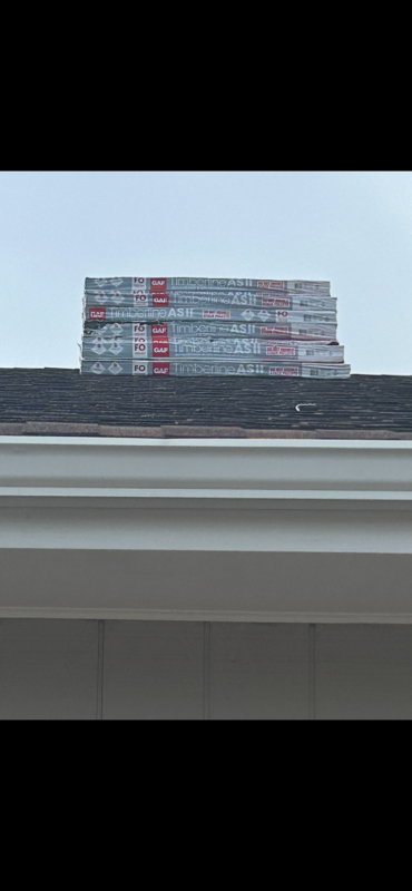 Bundles of GAF Timberline AS II Class 4 impact-resistant shingles staged on a roof